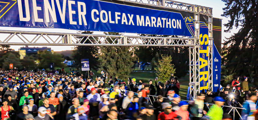 Denver Colfax marathon runners starting race under banner