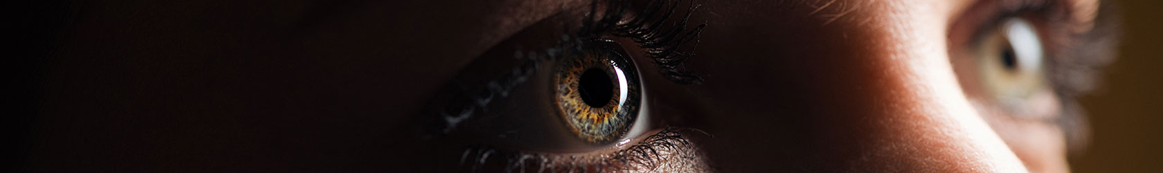 Close-up of woman's eyes looking up into the distance