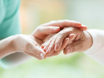 Close-up of younger and older woman holding hands