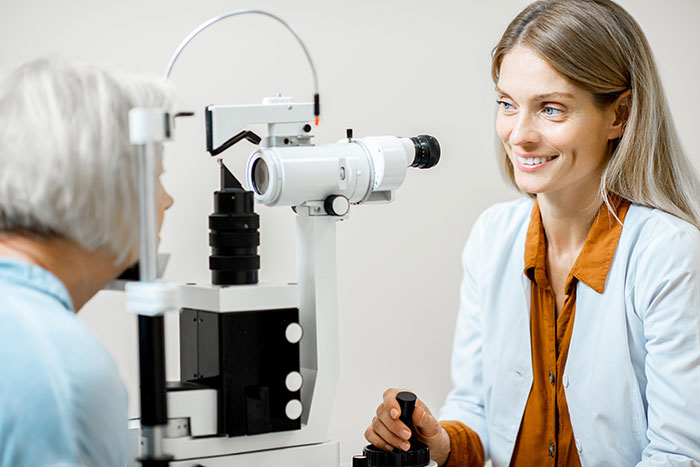 ophthalmologist examining eyes with a microscope