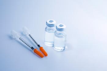 two vials of insulin with two syringes