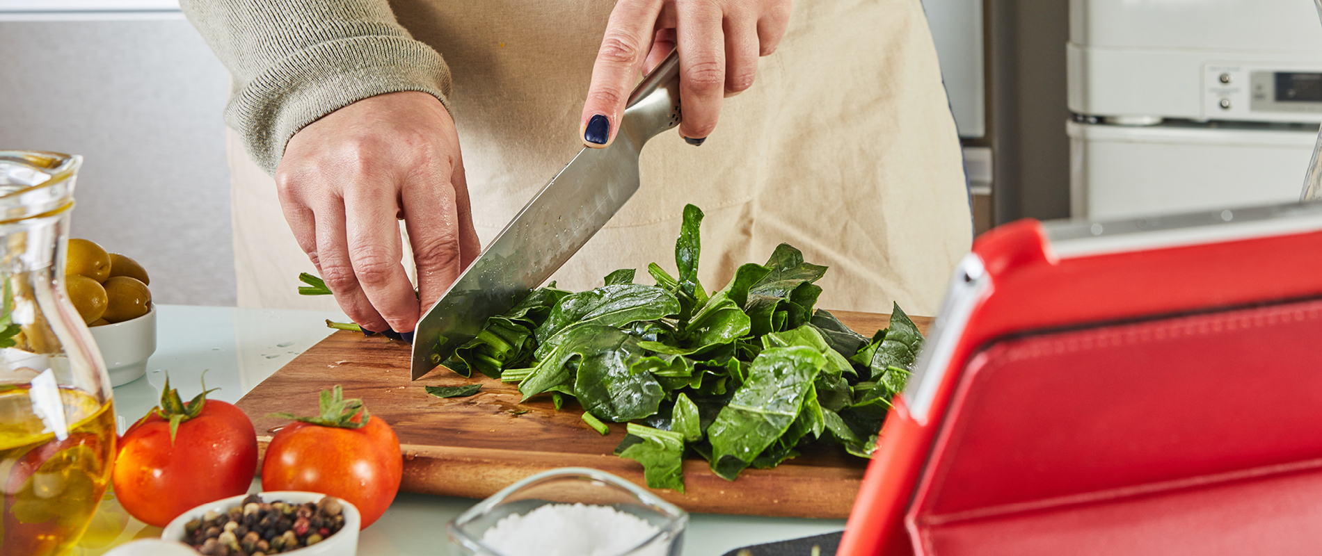 Chopping spinach on cutting board