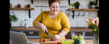 Heavy-set woman preparing healthy food in kitchen